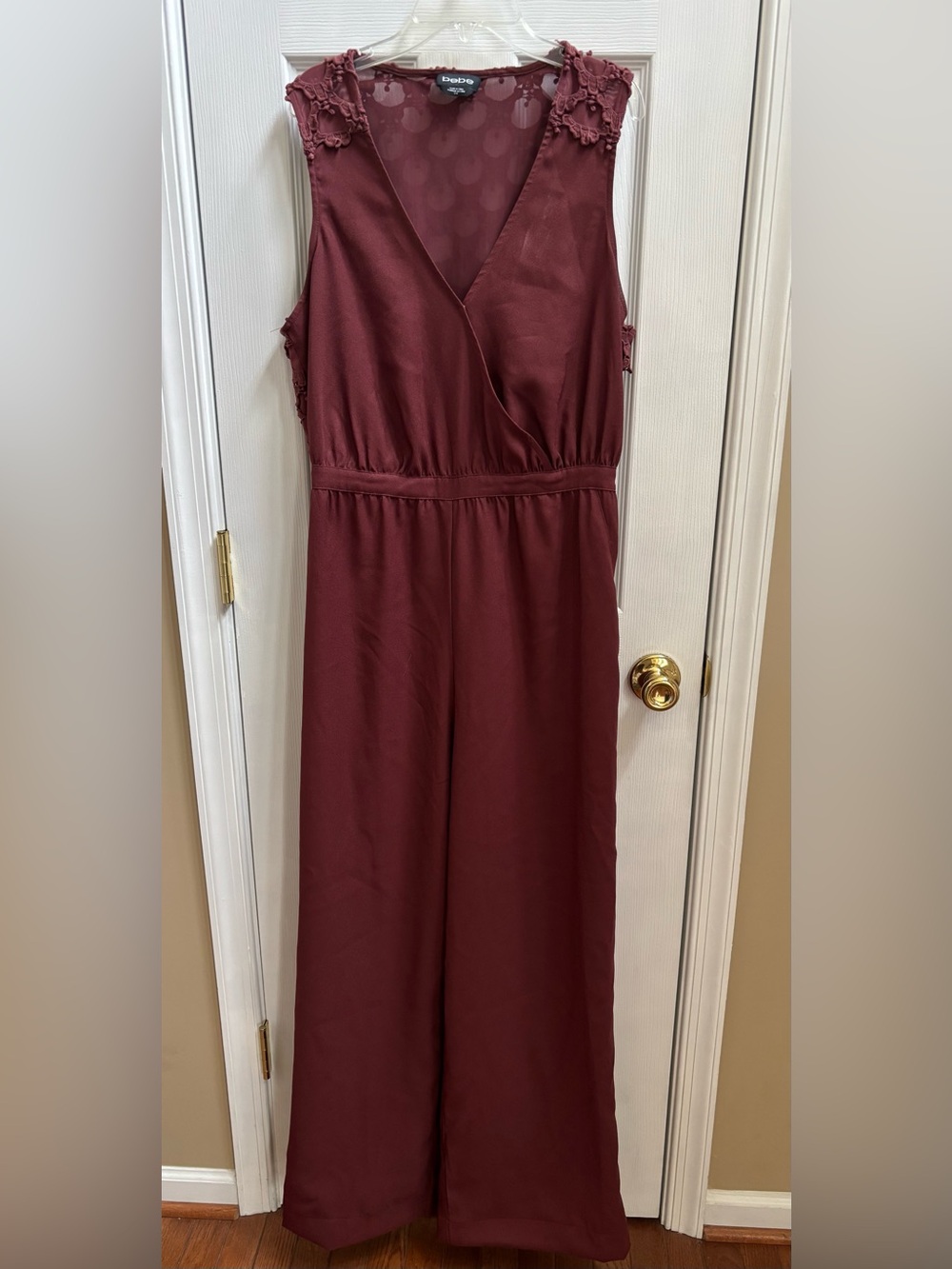 Bebe Woman’s Sleeveless Jumpsuit in Deep Burgundy w/ metal detail, Size L, NWOT